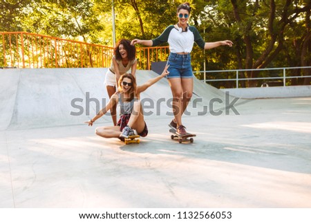 Similar – Happy young woman riding on skate with her friends