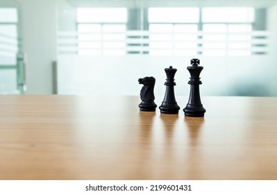 Three chess pieces on the table.