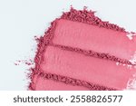 Three chic samples of pink blush on a white background. parallel strokes of loose dry blush. top view. A copy space. texture of cosmetics. close up