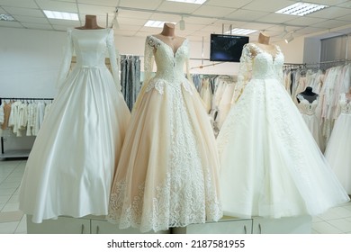 Three chic wedding dresses on mannequins. Three different models of beautiful wedding dresses. - Powered by Shutterstock