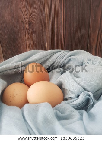 three chicken eggs in the basket
