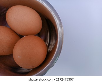 Three chicken eggs in close-up photo in a bowl. - Shutterstock ID 2192475307
