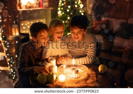 Three children, lighting candles in a nutshell, czech Christmas traditions, decorated room, family traditions