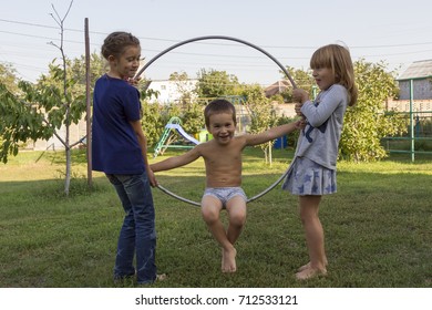 Three children play in the hoop park