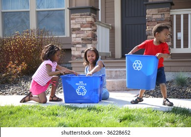 Three children putting items into recycle bin - Powered by Shutterstock