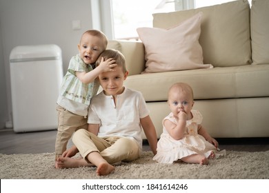 Three Children In The Room, Two Boys One Year And Four Years Old And A Girl 6 Months Old