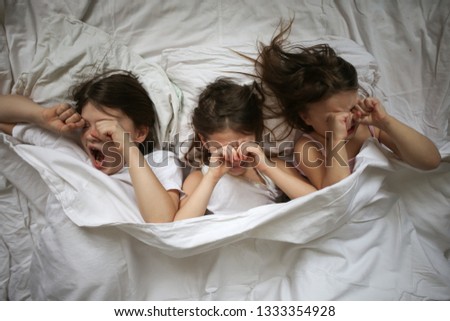 Similar – Little girl embracing doll lying over the bed