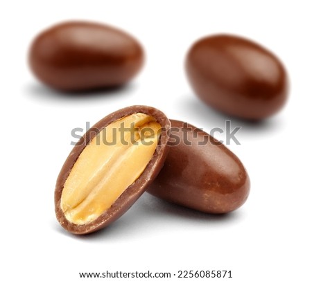three chocolate covered peanuts isolated
