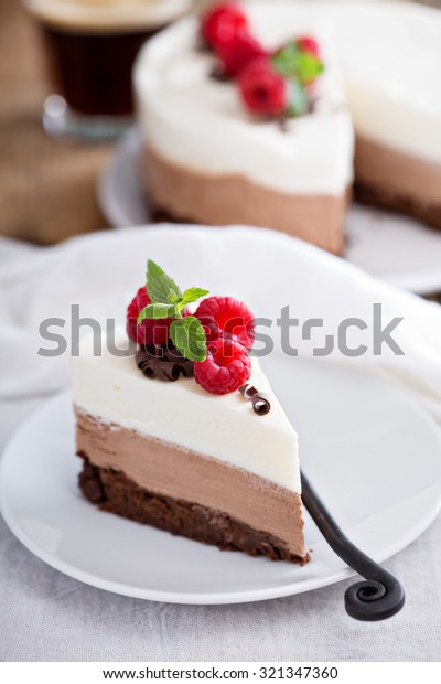 Three\
chocolate mousse cake slice on a small\
plate