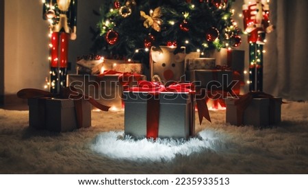 Three Christmas gift box on the white carpet with glowing lights