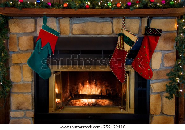 Three Christmas Stockings Hanging Over Fireplace Stock Photo Edit