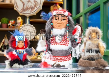 Three Chukchi toys in national clothes are on the table. Ethnic costumes of the peoples of the North of Russia. Close-up.