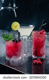 three classic cocktails on the bar in a nightclub, Set of three healthy nonalcoholic cocktails berries, Three tropical mixed drinks - Shutterstock ID 2070045350