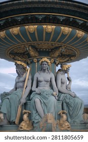 The three classical statues support the ornate fountain canopy.