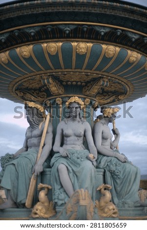 The three classical statues support the ornate fountain canopy.