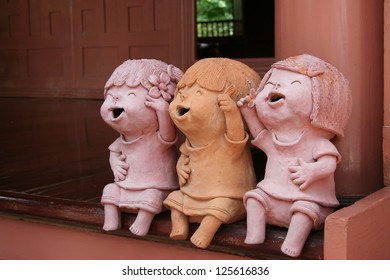 Three Clay doll girl place on terrace
