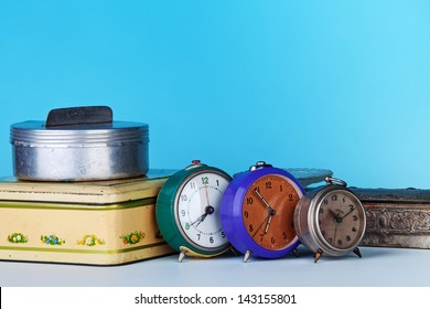 Three clocks, three boxes on a blue background