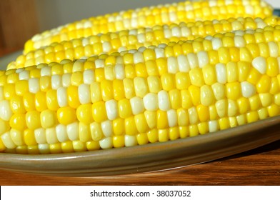 Three Cobs Of Bi-color Sweet Corn On A Plate