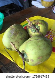 Three coconuts on the table in the kitchen