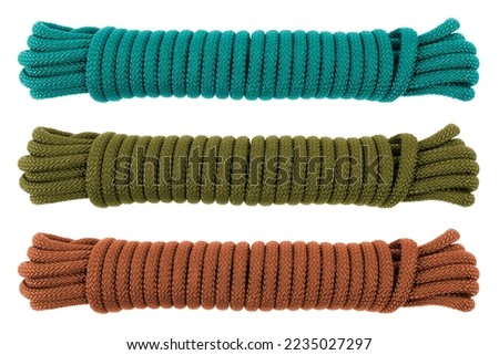 Three coiled nylon rope isolated on white background. Striped nylon rope different color isolated. A coil of new colored rope.