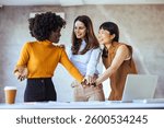 Three colleagues actively collaborating and sharing ideas in a bright office setting, embracing teamwork and diversity in a professional environment.