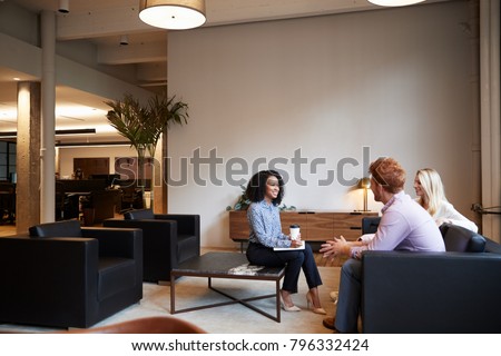 Similar – Group of young adults having business meeting in start up office