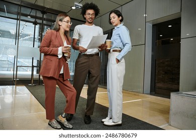 Three colleagues chat and review paperwork in an office lobby, one woman with a prosthetic leg. - Powered by Shutterstock