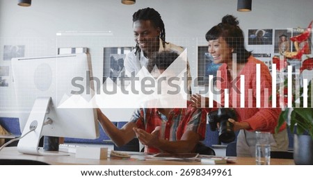 Three colleagues collaborating around computer monitor in office, with DSLR camera and notebooks. Collaboration, teamwork, modernoffice, digitalgraphics, creativeworkspace, innovation, startup