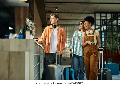 Three colleagues smile and chat while checking in at a contemporary hotel lobby.