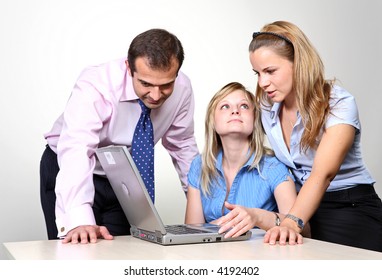 Three colleagues working at a computer.