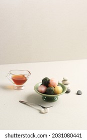 Three Color Kkultteok is Ball Shaped Rice Cake Filled with Honey and Sesame Syrup, Korean Traditional Cake for Chuseok Day. Concept Korean Culture