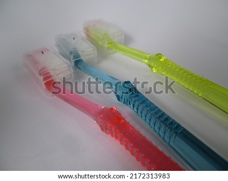 Three color toothbrush on white background