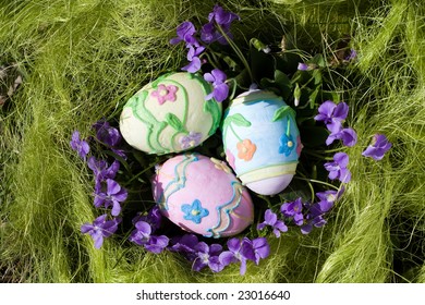 Three colored easter eggs in the green grass