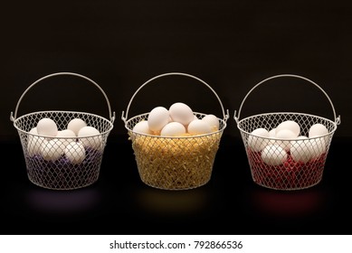 Three colorful baskets full of white eggs. - Powered by Shutterstock