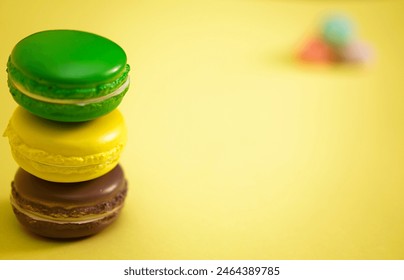 Three colorful macarons stack together