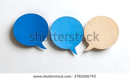 Three colorful speech bubbles, two blue and one beige, arranged in a row on a clean white surface.