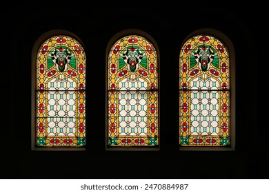 Three colorful stained glass windows in a row inside the Synagogue of Novi Sad, Serbia 2022