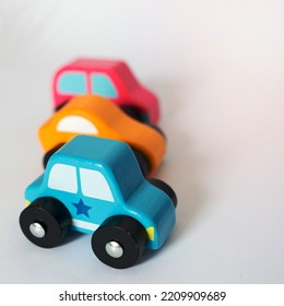 Three Colorful Toy Cars In A Row With White Background