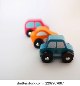 Three Colorful Toy Cars In A Row With White Background