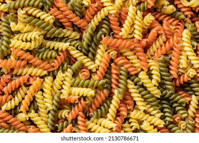 Three colors fusilli pasta. Colorful italian raw pasta. Top view. - Powered by Shutterstock