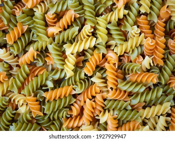 Three Colors Rotini Pasta. Pasta fusilli tricolore background. Abstract texture of colorful pasta. Pattern of macaroni. Bright multicolor food backdrop. Uncooked colored noodles. - Powered by Shutterstock