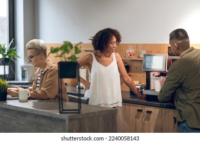 Three company employees in the office kitchen - Powered by Shutterstock