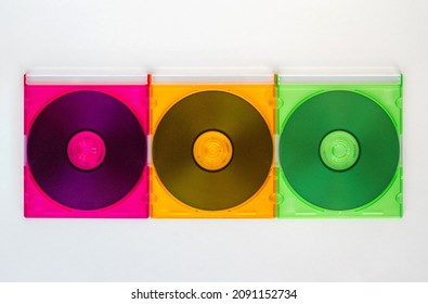 Three computer CD disks in multiciolored boxes
