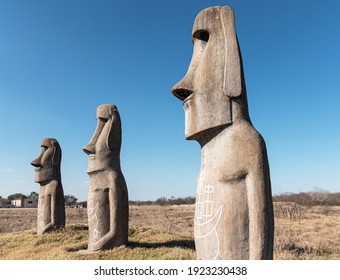 Three Concrete Statues In A Open Field In Texas