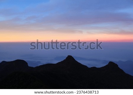 The three cone shape mountains and the magical sunrise sky at Adam's Peak, Sri Lanka. Copy space for text, horizontal image