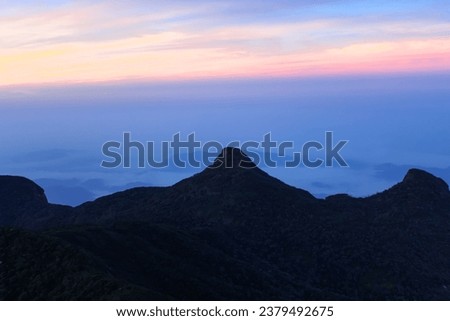 The three cone shape mountains and the magical sunrise sky at Adam's Peak, Sri Lanka. Copy space for text, horizontal image
