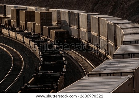Three container trains parallel at sunset