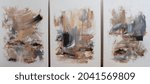 Three contemporary abstract paintings on the art studio. Nonfigurative abstract paintings of the same artistic series with colorful stains and strong brush texture.