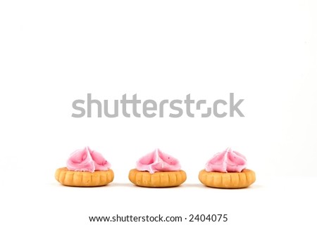 three cookies with pink sugar, isolated on white background