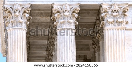 Three Corinthian capitals create a balanced detail of the Supreme Court colonnade.